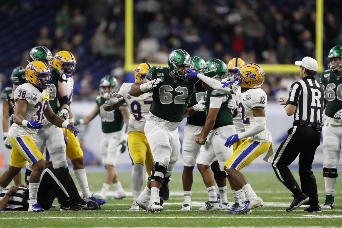 Dec 26, 2019; Pitt Panthers defensive back Paris Ford (12) grabs the facemask of Eastern Michigan Eagles offensive lineman Sidy Sow (62). Mandatory Credit: Raj Mehta-USA TODAY